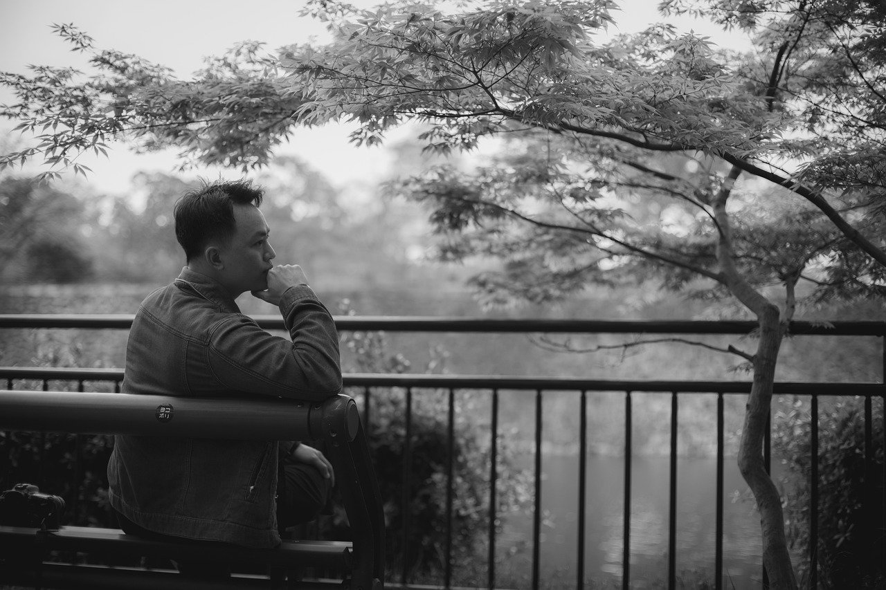 Pensive man by water